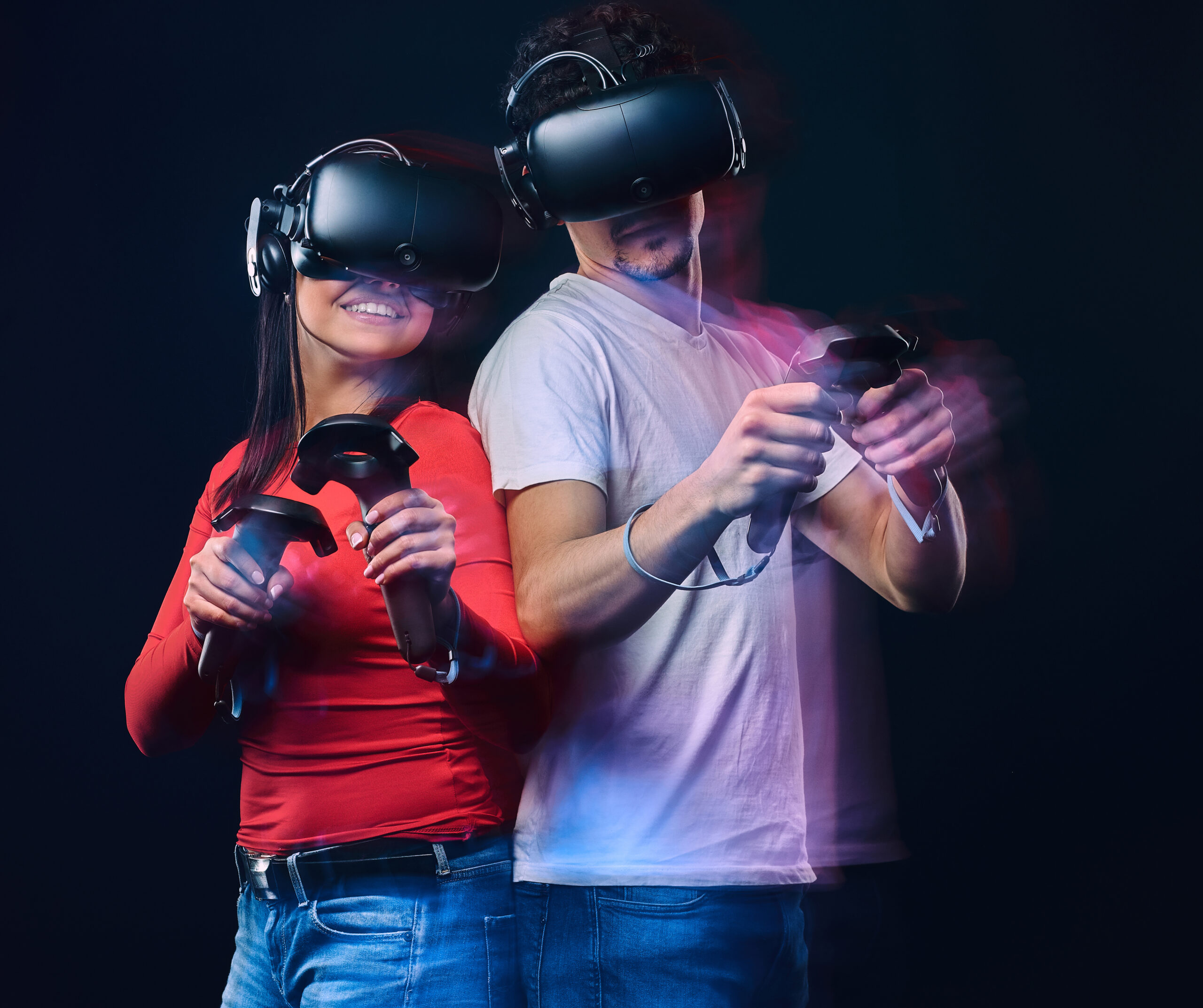 gallery-2 Happy Friends Playing Video Games Wearing Virtual Reality Glasses With Controllers Isolated Dark Background Photo With Light Effect Scaled