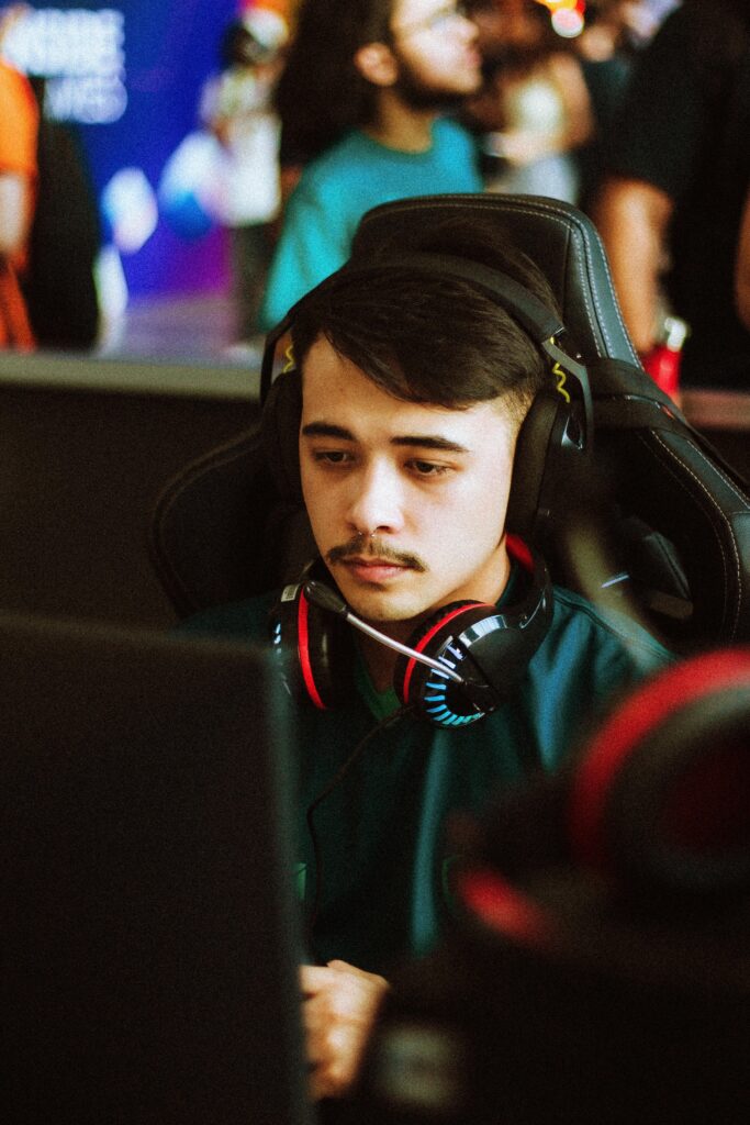 pexels photo 30324913 30324913 Young male gamer intensely focused at an esports tournament, wearing headphones.